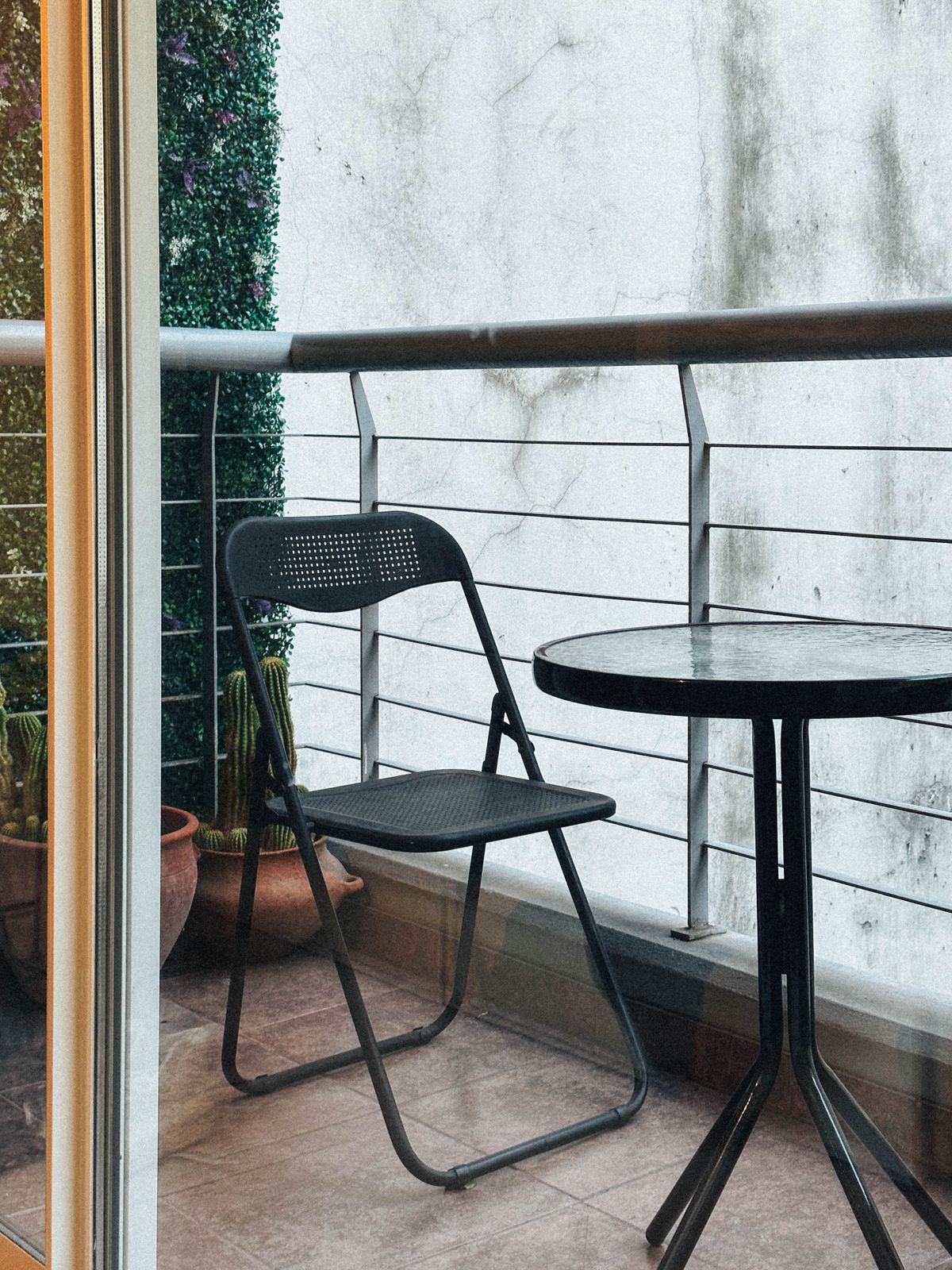 Balcony arranged with a compact chair and table