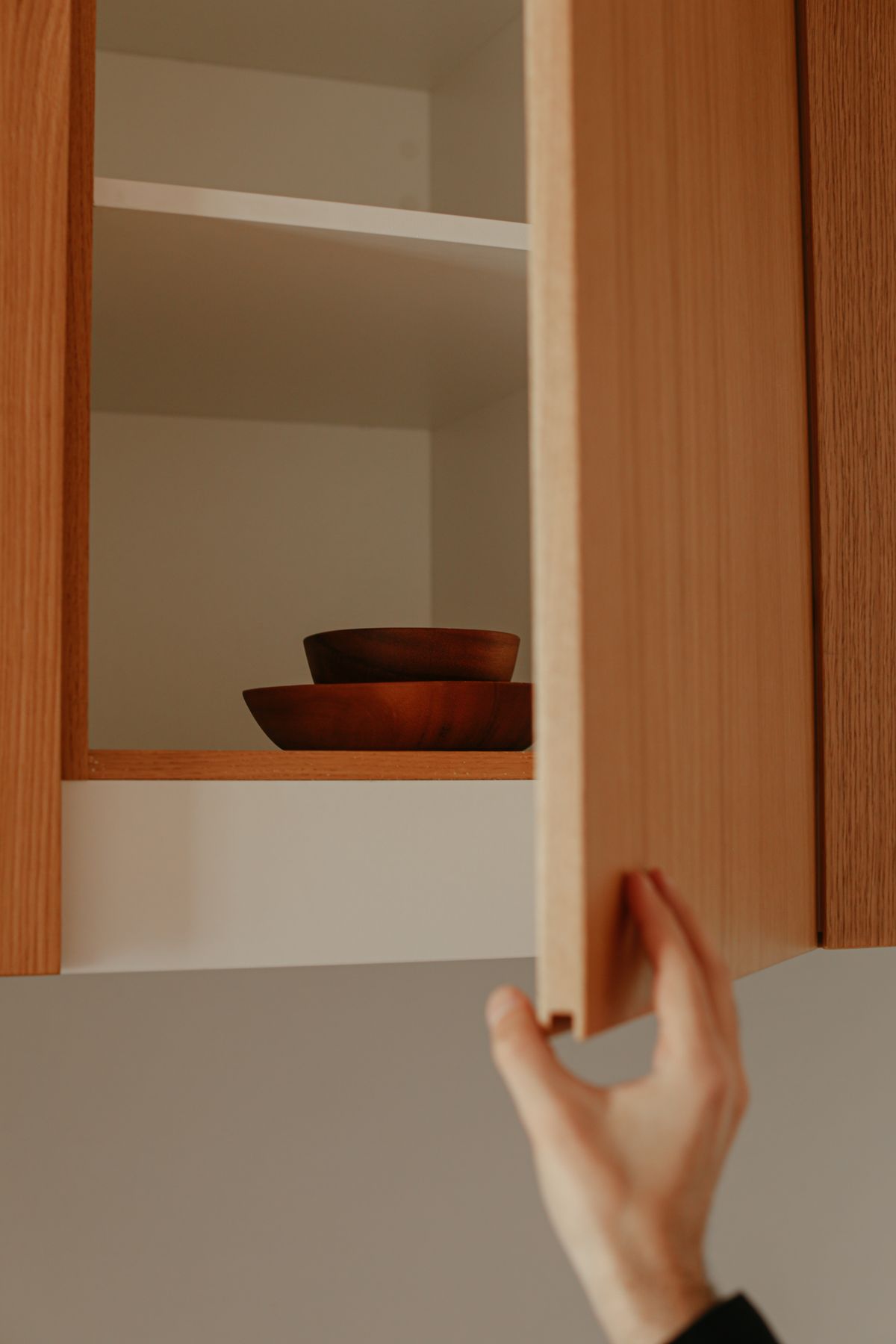 A kitchen cabinet door being opened