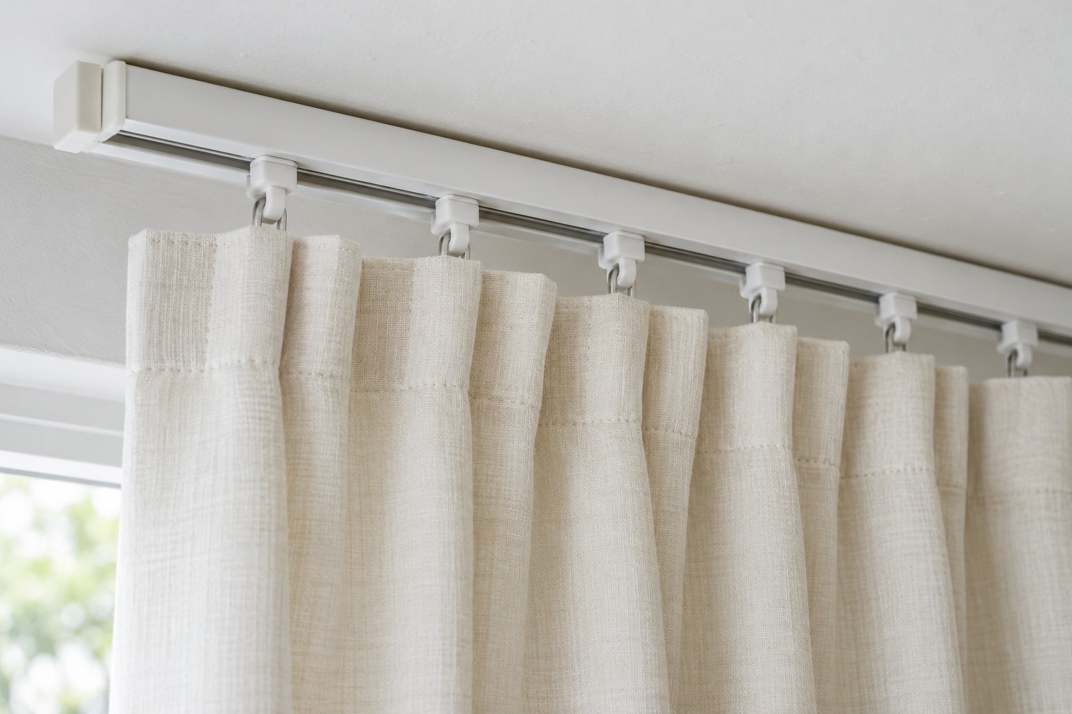 Illustrative AI image: Curtain-track channel and small plastic gliders above a cream curtain