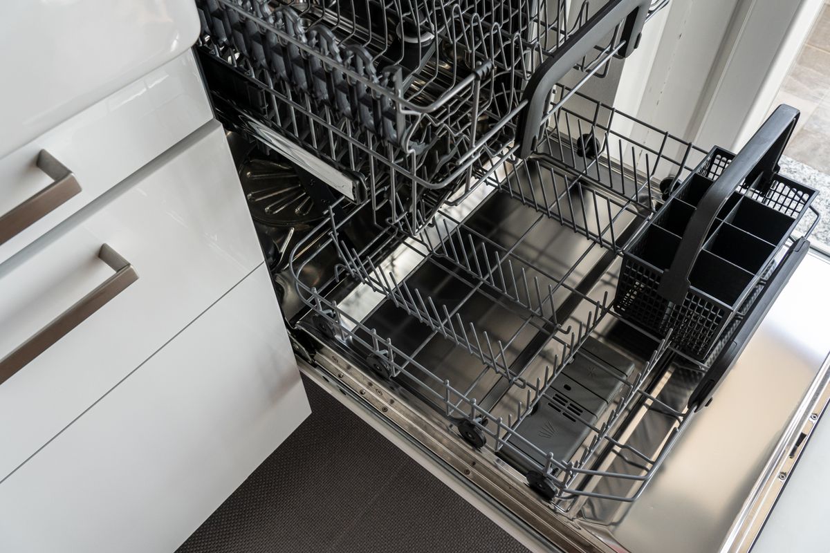 The open interior of an empty dishwasher