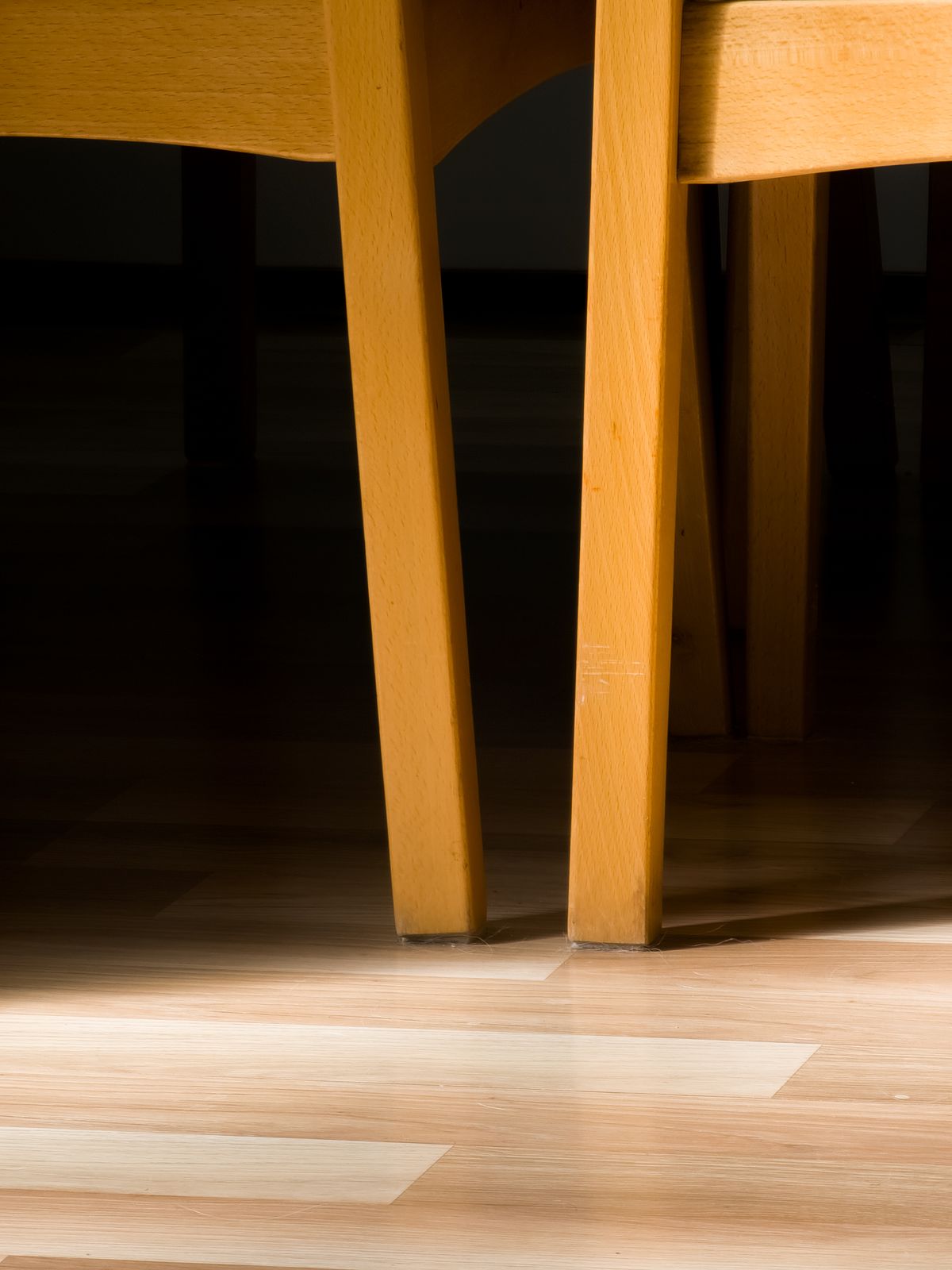 Wooden chair legs standing on a floor