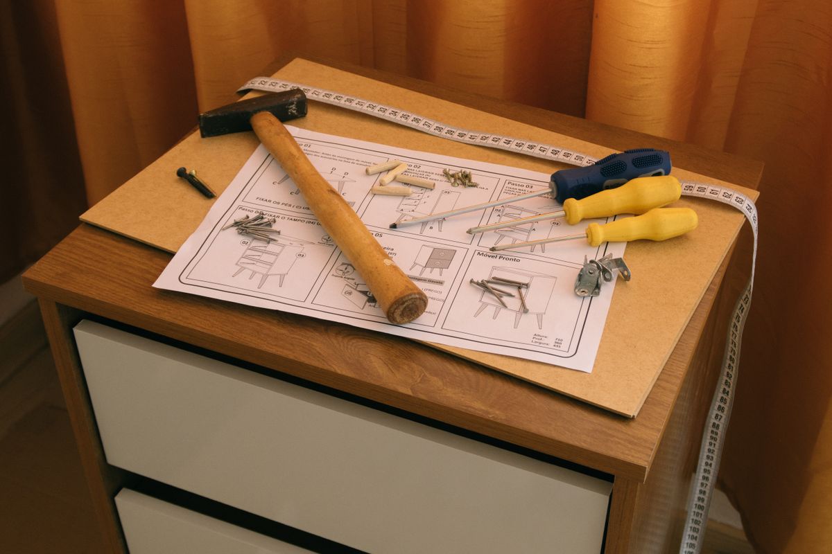 Furniture parts with assembly instructions and tools