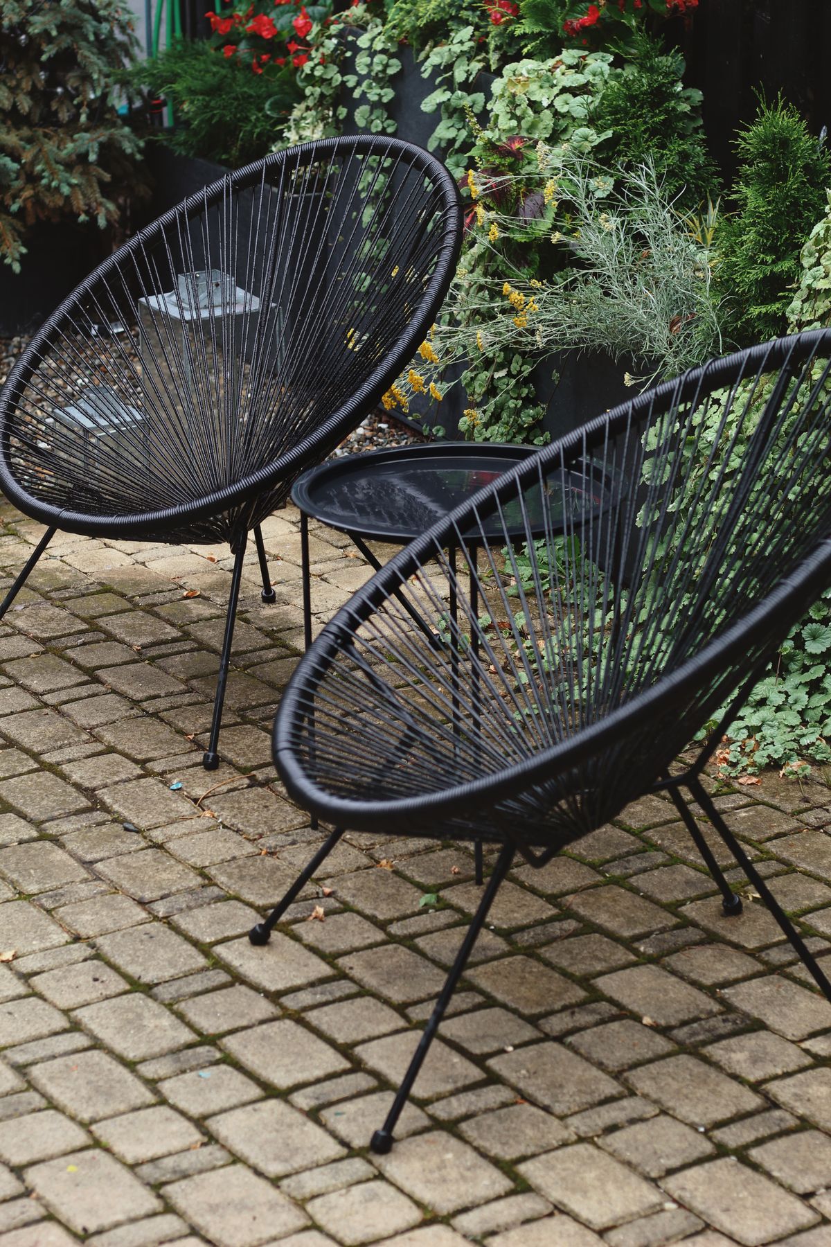 Garden chairs standing on a brick patio
