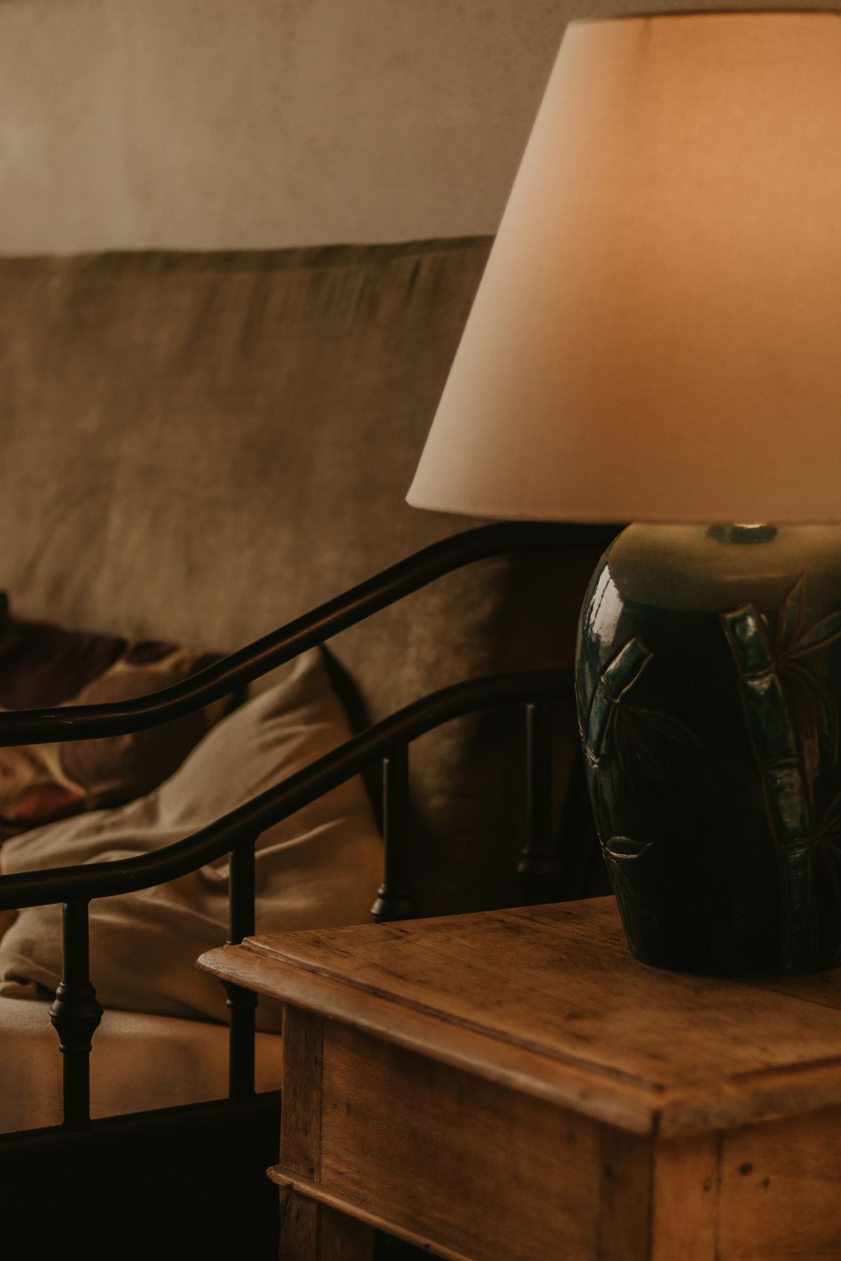 A fabric-shaded table lamp beside a sofa