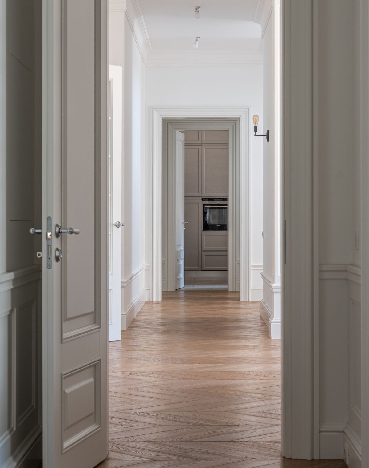 White painted skirting and mouldings along a hallway floor