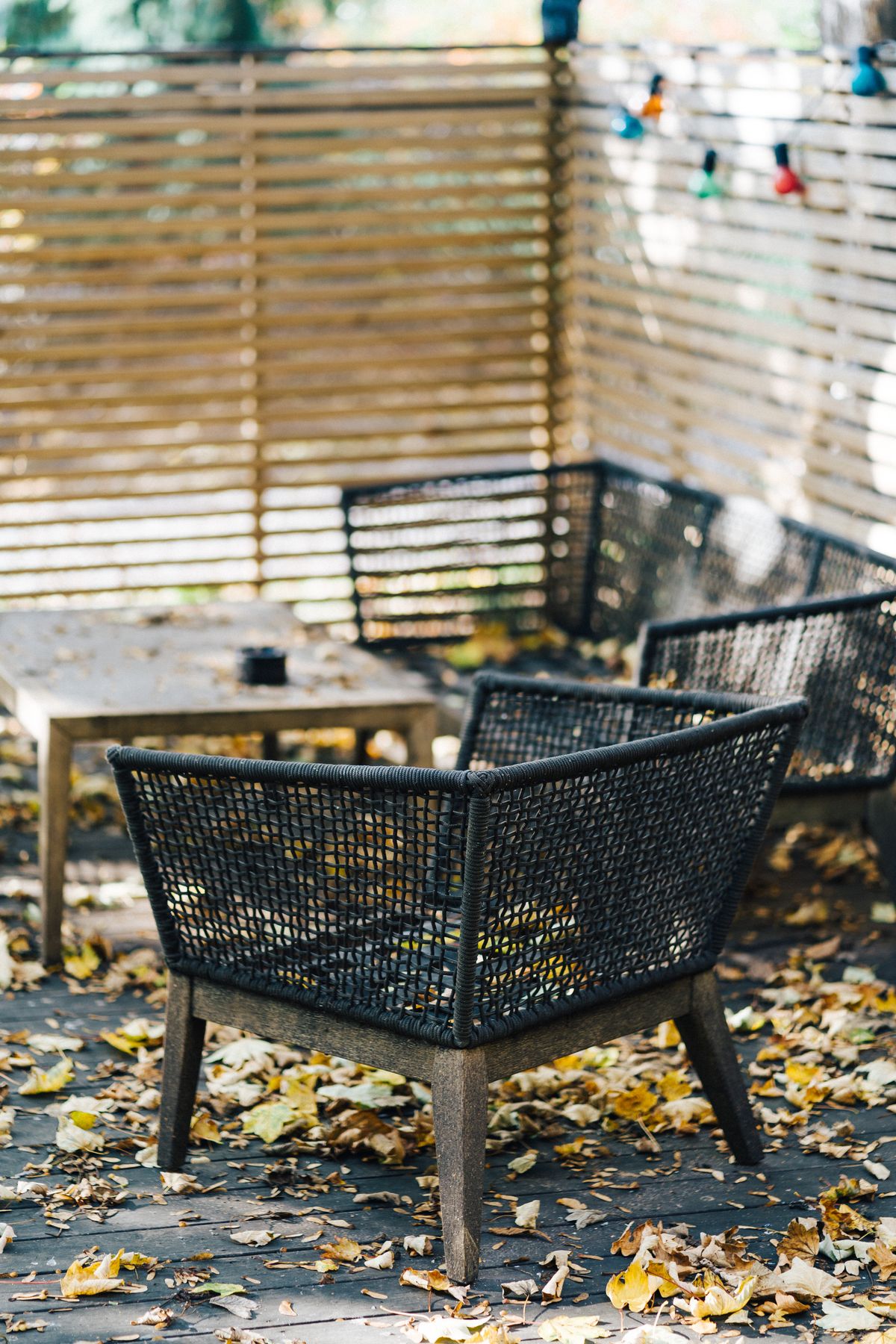 Patio furniture surrounded by fallen autumn leaves