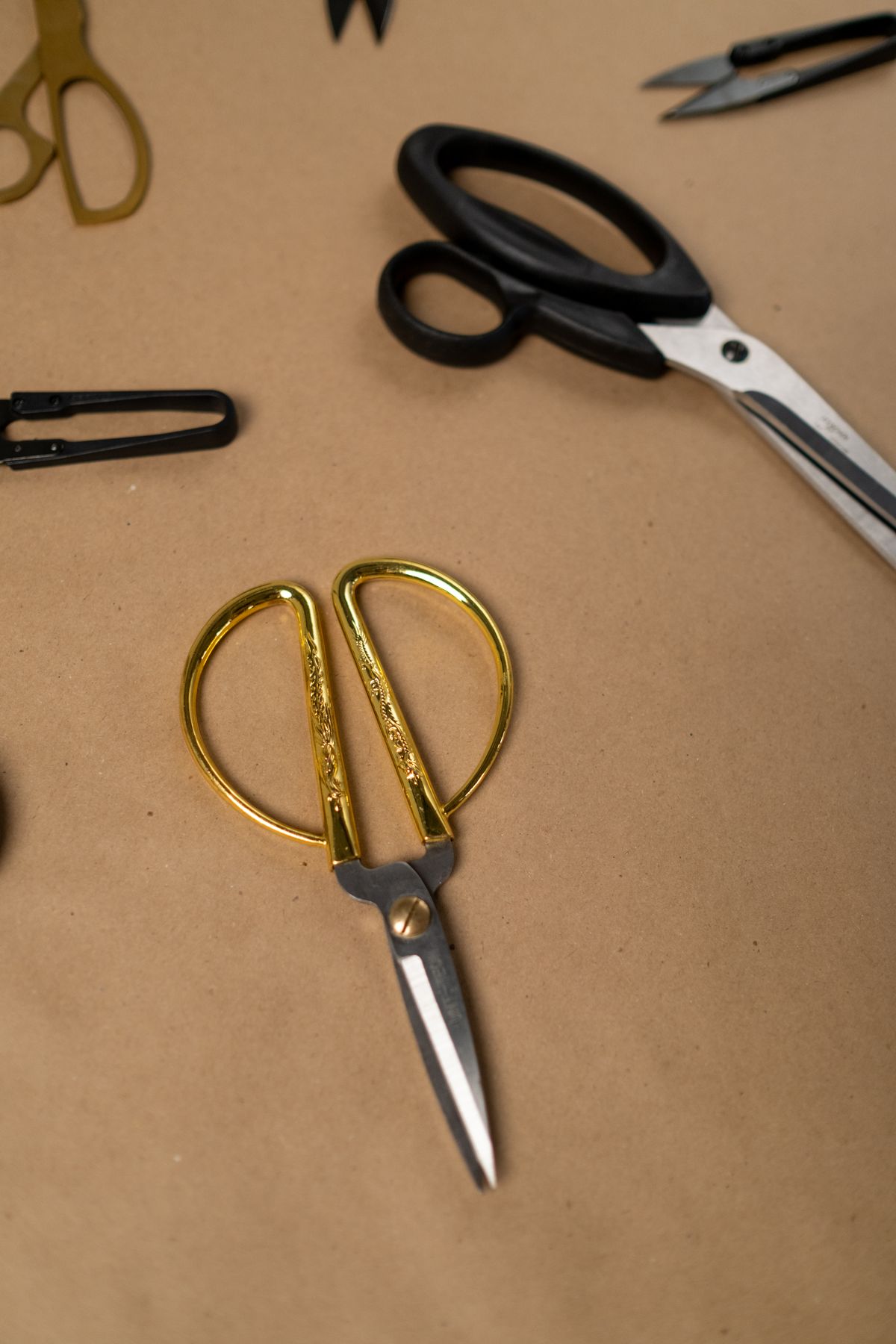 Scissors resting on brown craft paper