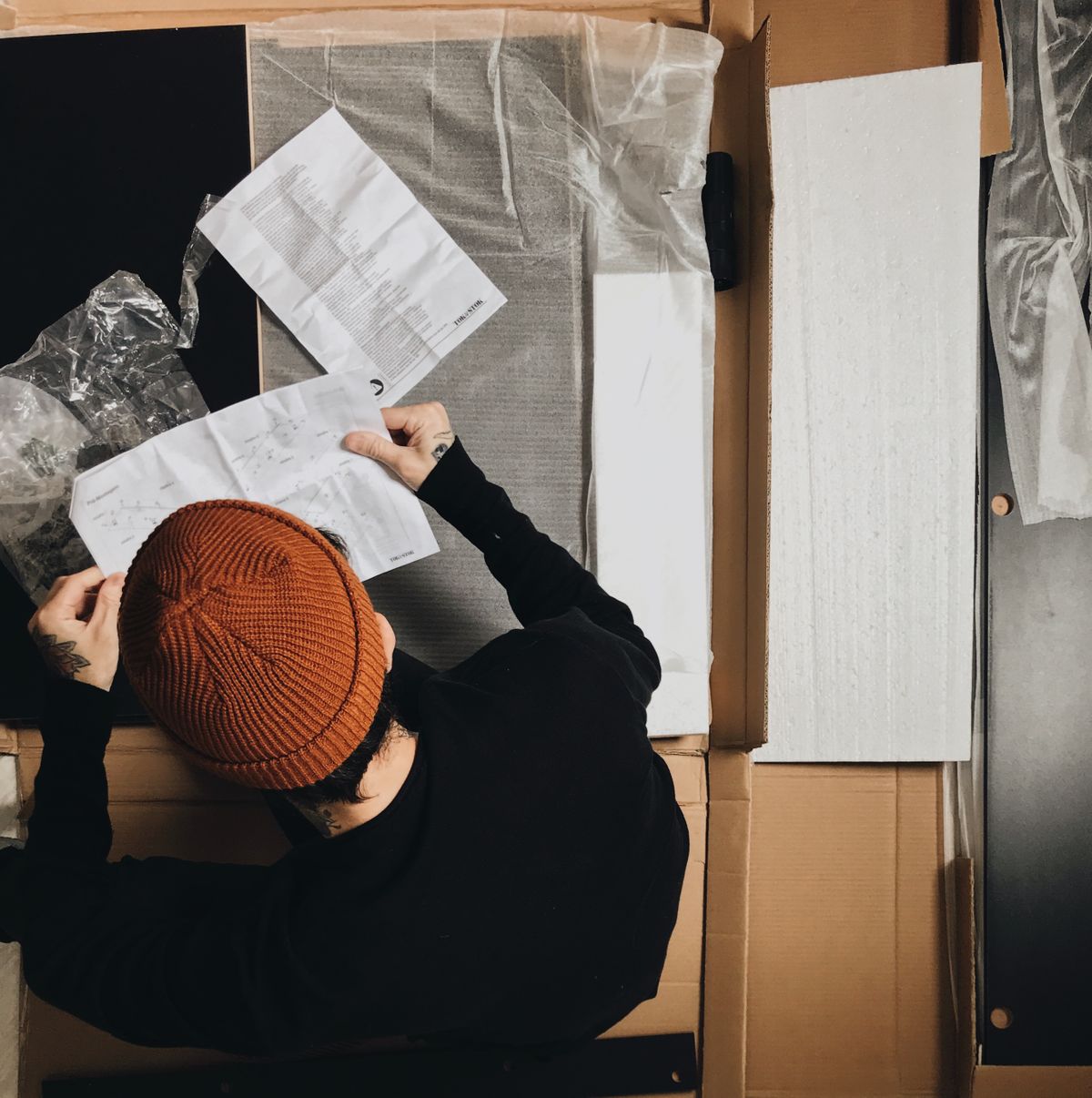 A person reading assembly instructions before continuing