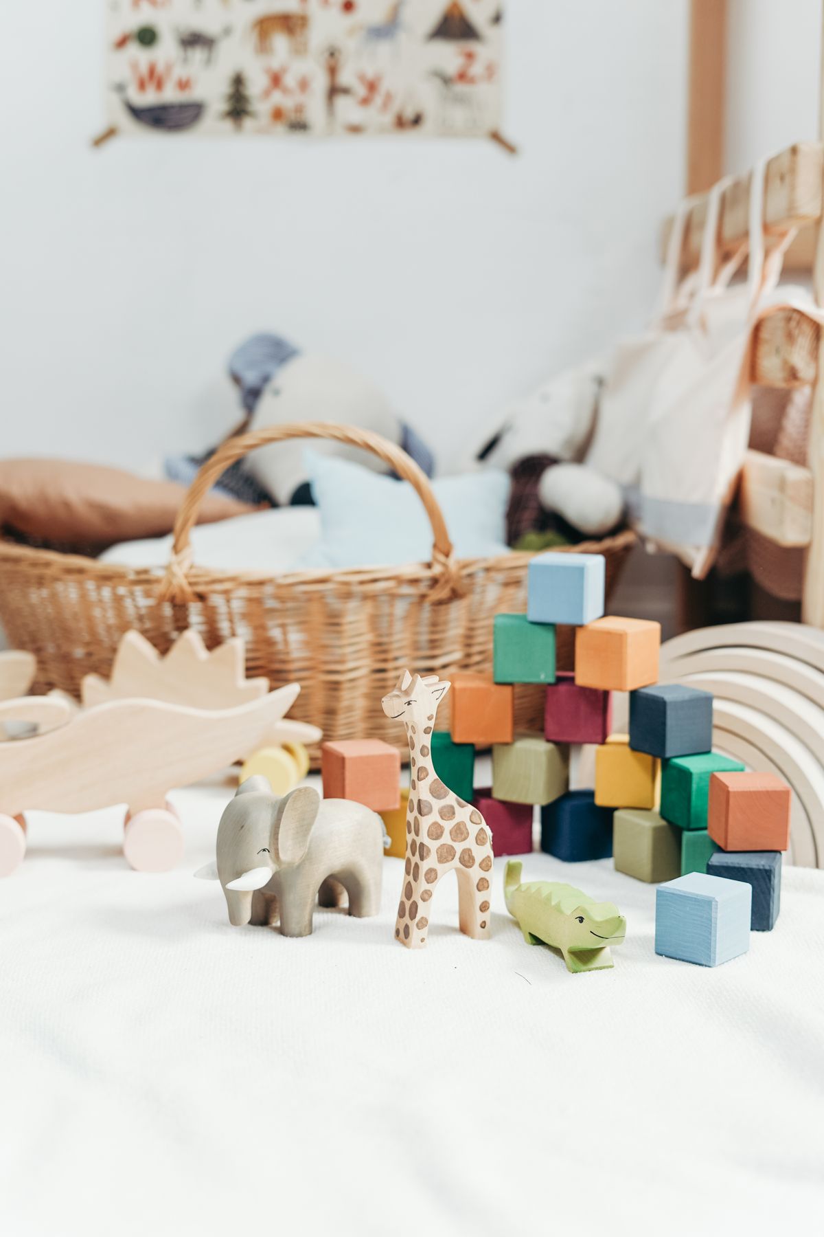 Wooden toys beside a wicker basket