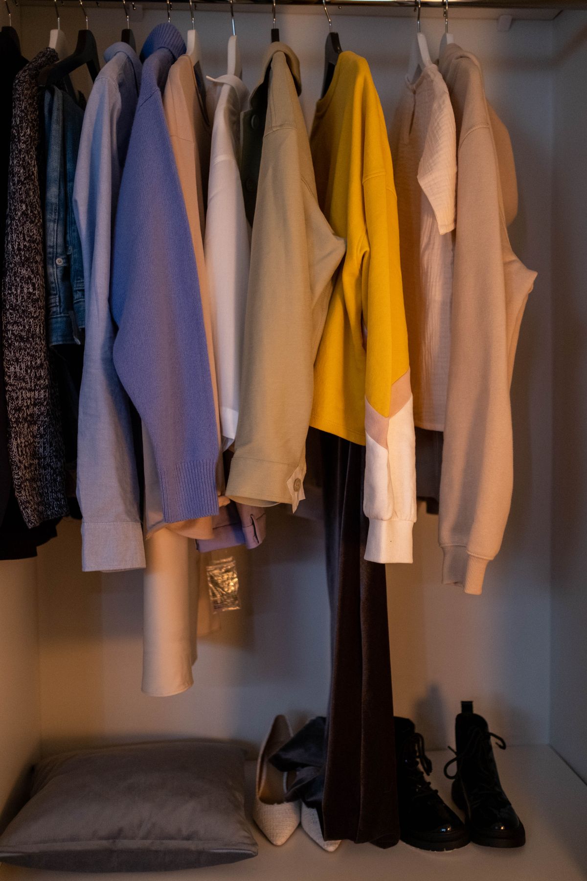 Clothes and shoes arranged inside a wardrobe