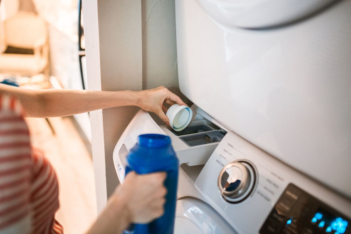 A washing machine detergent drawer being used